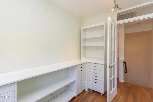 a view of walk in closet with empty racks