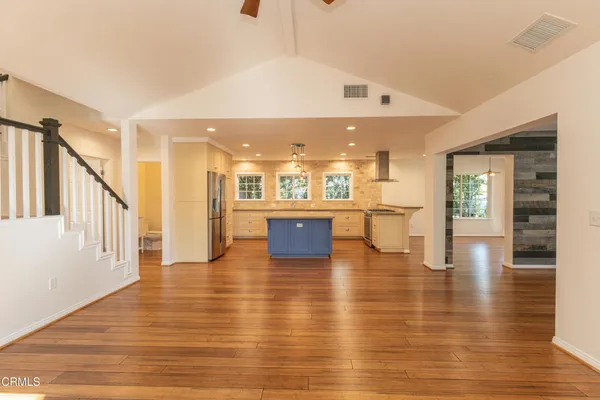 a view of a living room kitchen with a table and chairs