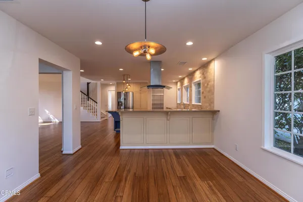a view of a room with wooden floor and windows