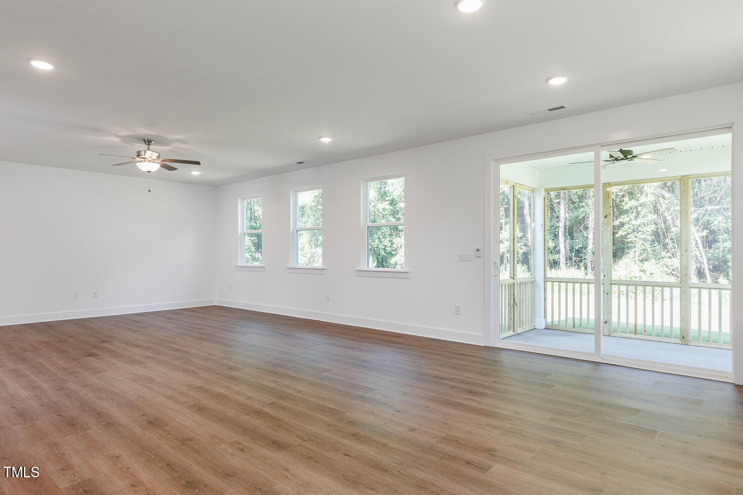 283 Golfview Avenue Four Oaks, NC 27524 - Photo 14 of 25 a view of an empty room with wooden floor and a window