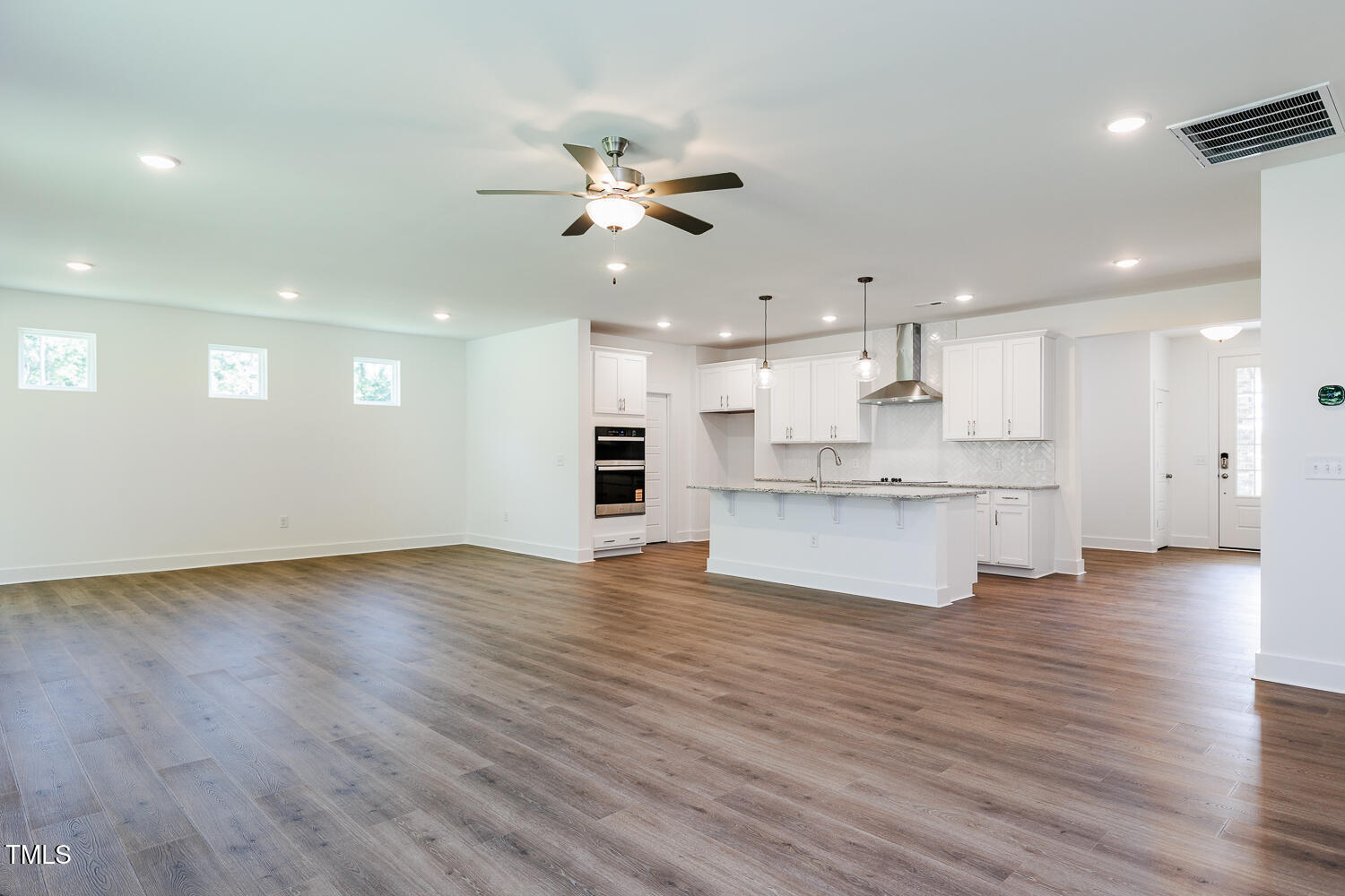 283 Golfview Avenue Four Oaks, NC 27524 - Photo 15 of 25 a view of an empty room with kitchen appliances and a kitchen view