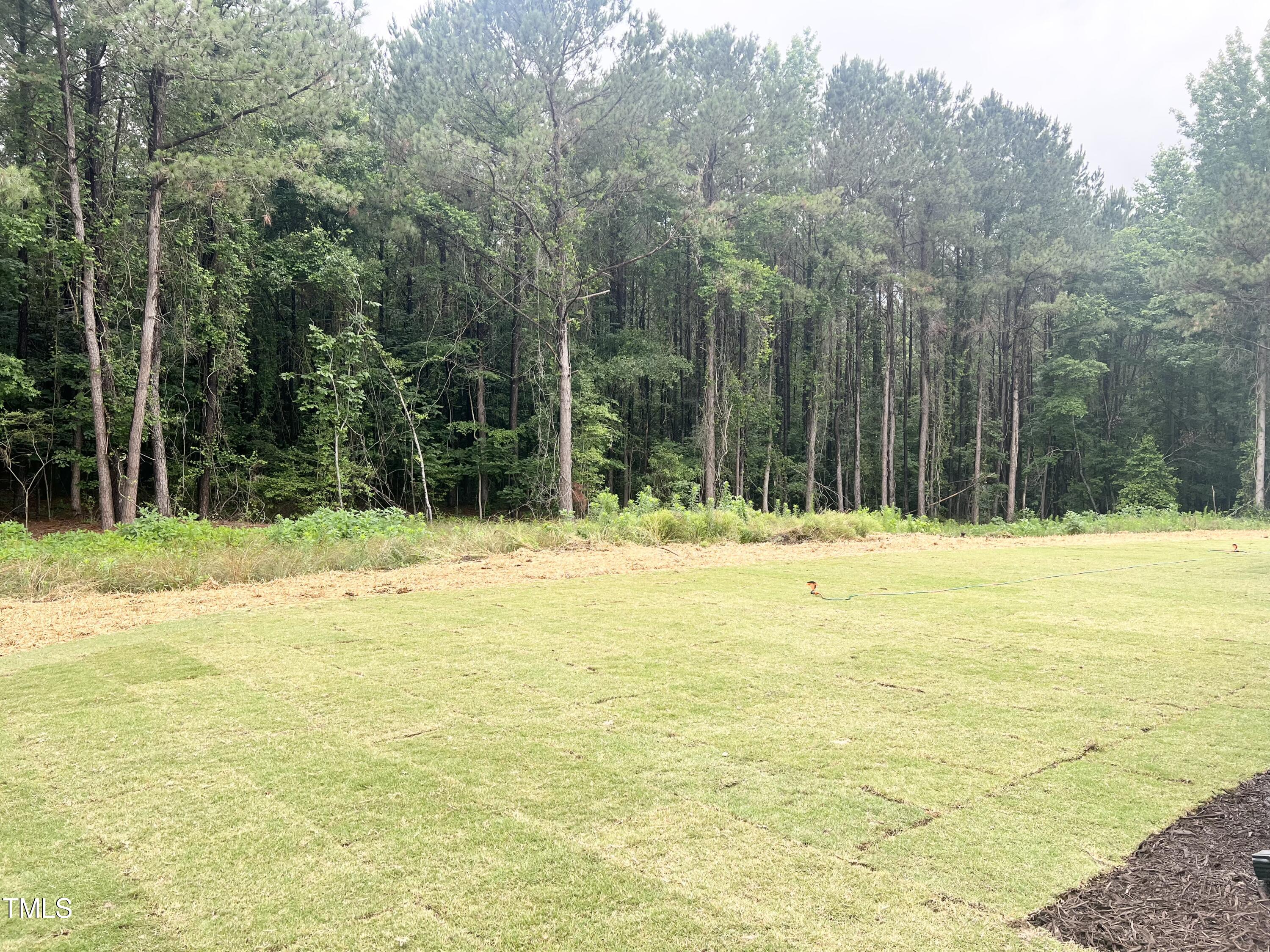 283 Golfview Avenue Four Oaks, NC 27524 - Photo 7 of 25 a swimming pool that has lawn chairs and wooden fence