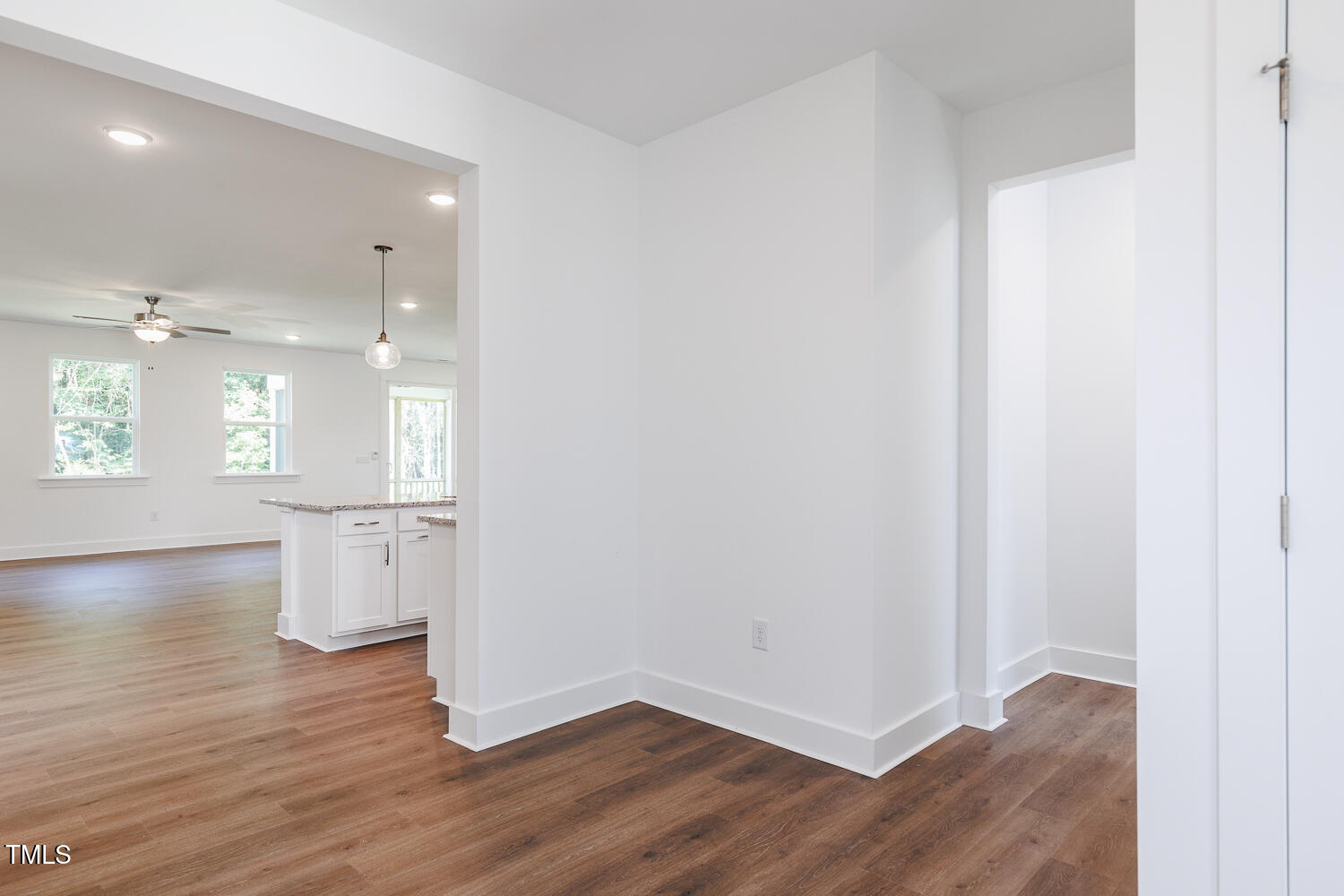 283 Golfview Avenue Four Oaks, NC 27524 - Photo 9 of 25 an empty room with wooden floor and windows
