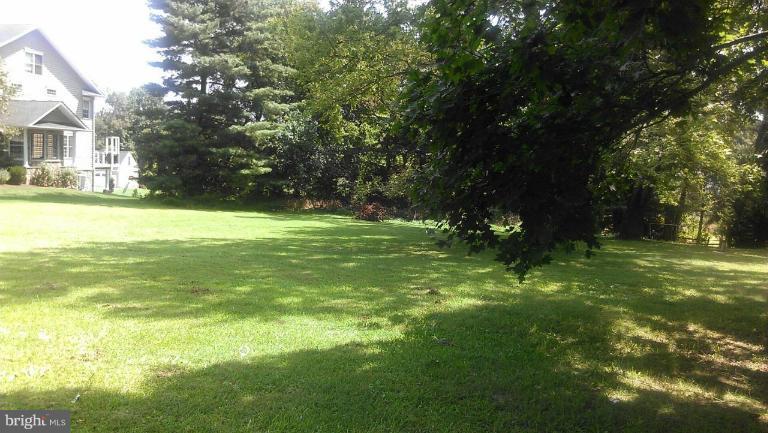 3 Sunset Farm Road Ellicott City, MD 21042 - Photo 1 of 4 a view of a trees in a yard with a house