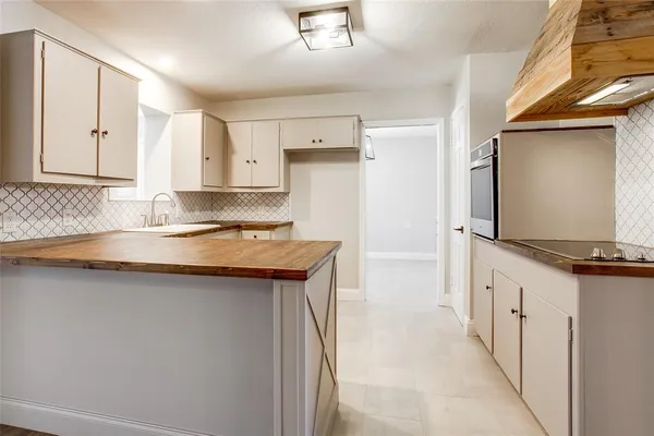 a kitchen with stainless steel appliances granite countertop a sink and a refrigerator