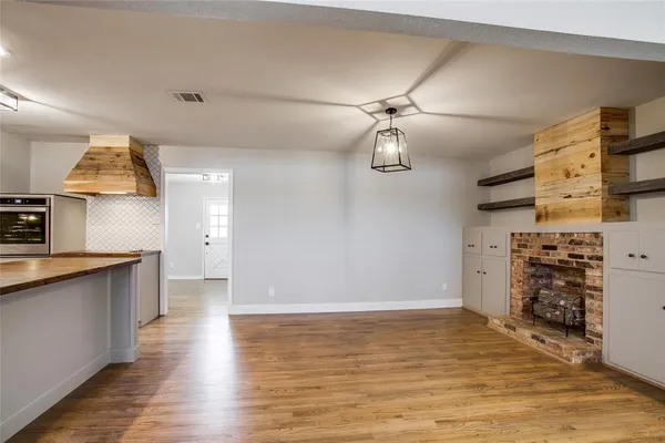 a view of a kitchen with a stove cabinets and wooden floor