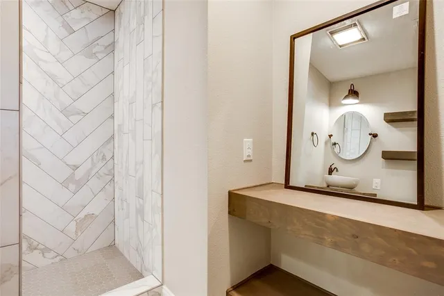 a bathroom with a mirror and a shower