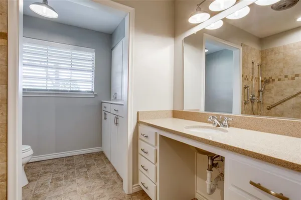 a bathroom with a sink a vanity and a mirror