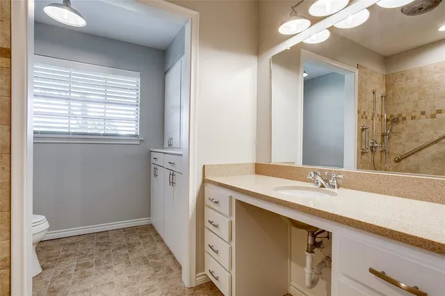 a bathroom with a sink a vanity and a mirror