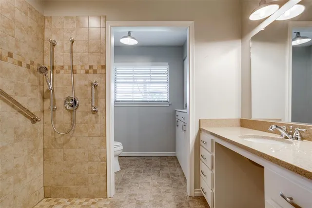 a bathroom with a sink shower and a mirror