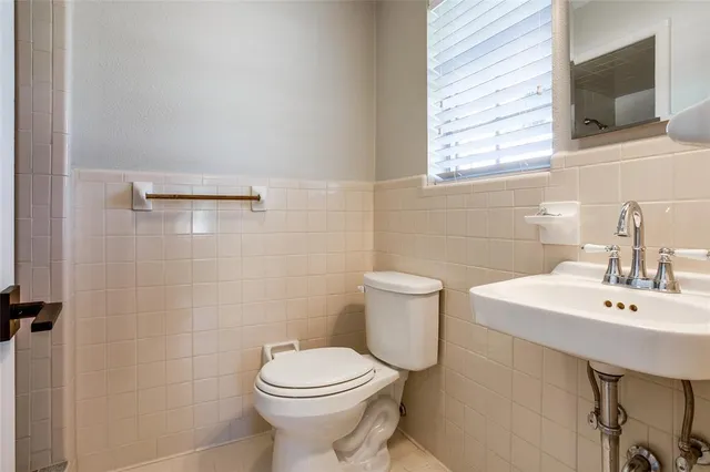 a bathroom with a sink a toilet and mirror
