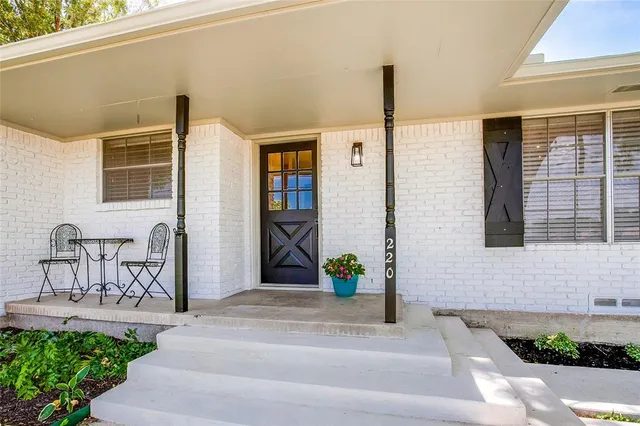 a front view of a house with outdoor seating