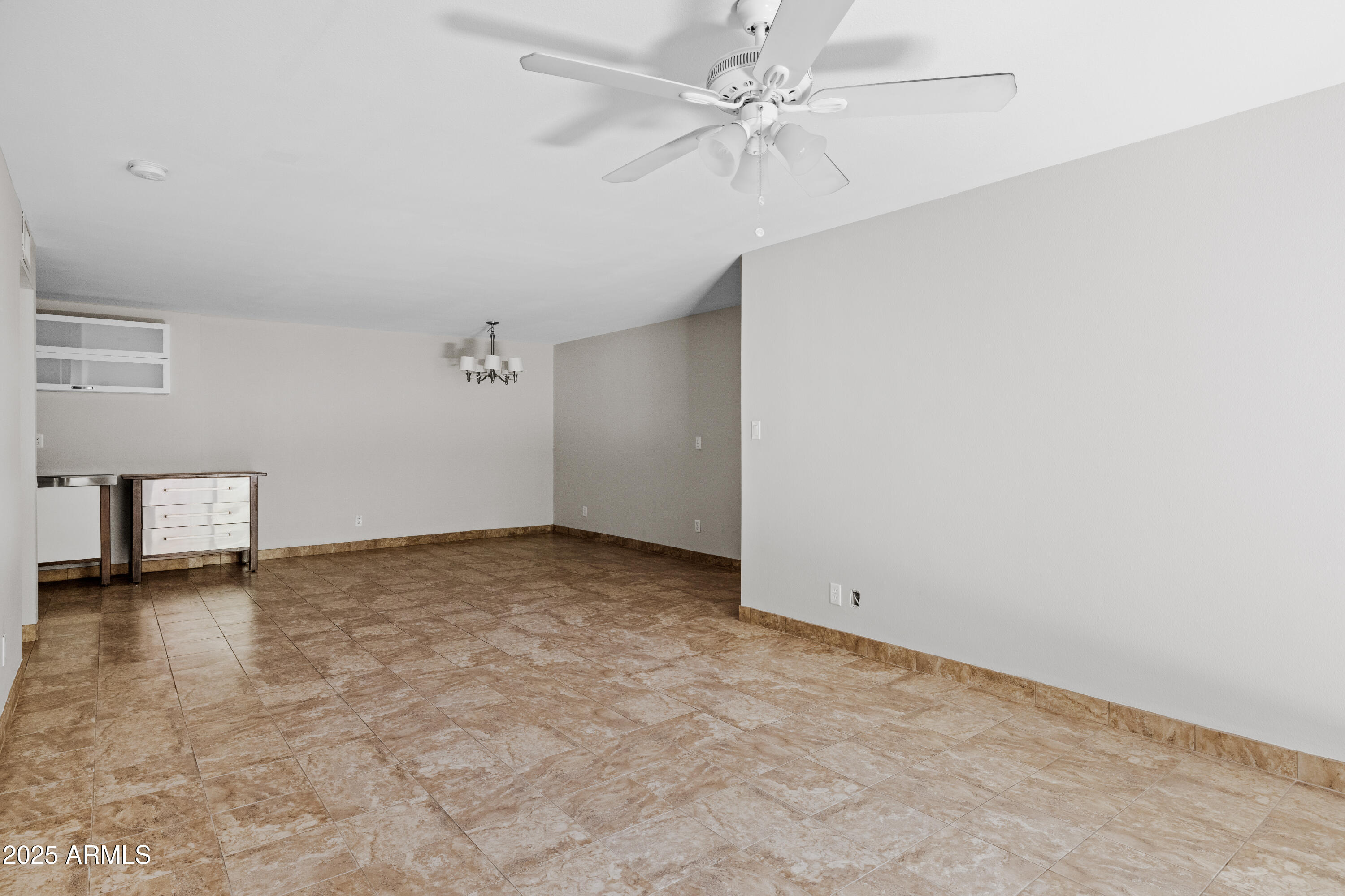 5525 East Thomas Road, Unit R11 Phoenix, AZ 85018 - Photo 5 of 15 an empty room with windows and fan