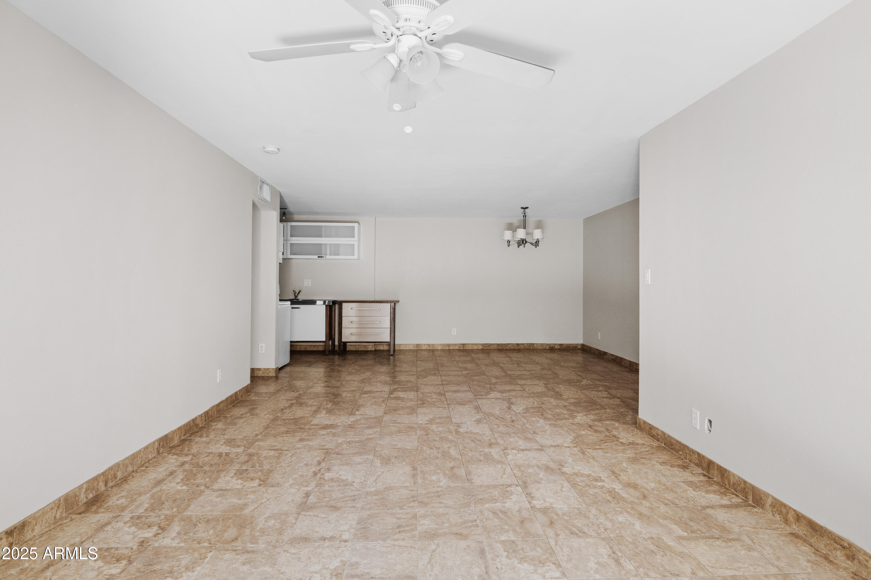 5525 East Thomas Road, Unit R11 Phoenix, AZ 85018 - Photo 7 of 15 an empty room with a ceiling fan and carpet