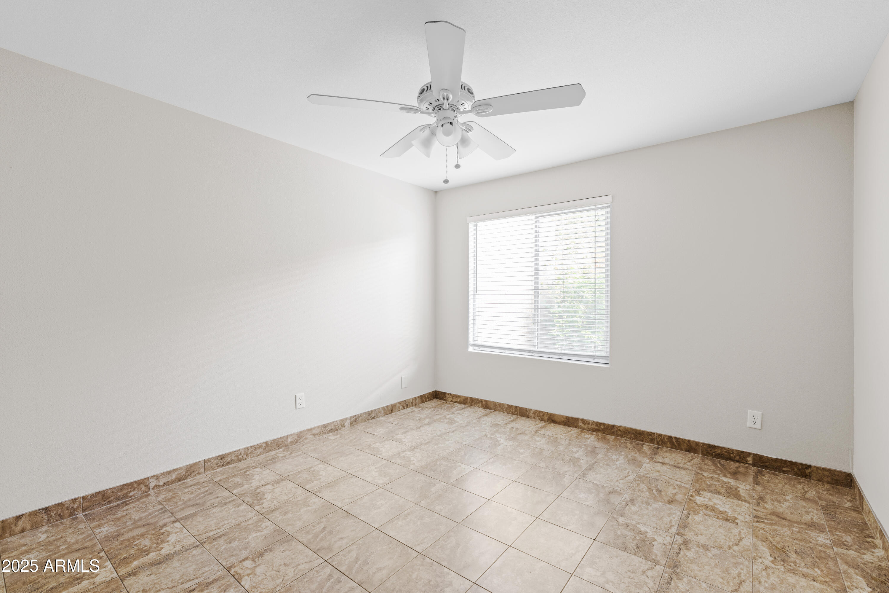 5525 East Thomas Road, Unit R11 Phoenix, AZ 85018 - Photo 10 of 15 an empty room with a chandelier fan and windows