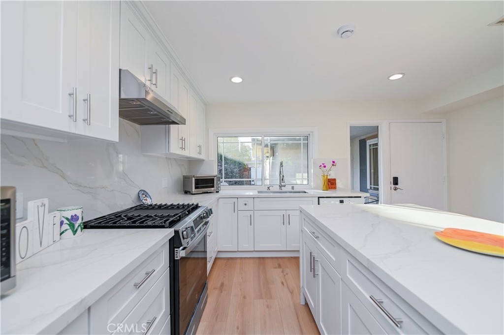 15 Camphor South Irvine, CA 92612 - Photo 1 of 28 a kitchen with granite countertop a sink stove and cabinets