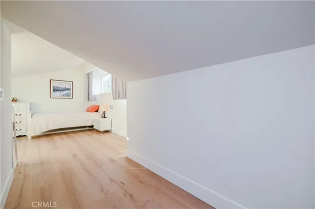 a bedroom with furniture and wooden floor