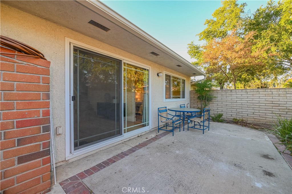 15 Camphor South Irvine, CA 92612 - Photo 26 of 28 a view of a patio with table and chairs and floor to ceiling window and tree