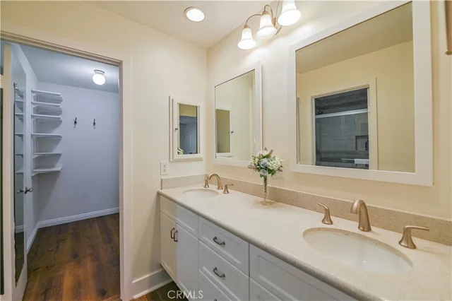 a bathroom with a double vanity sink and a mirror