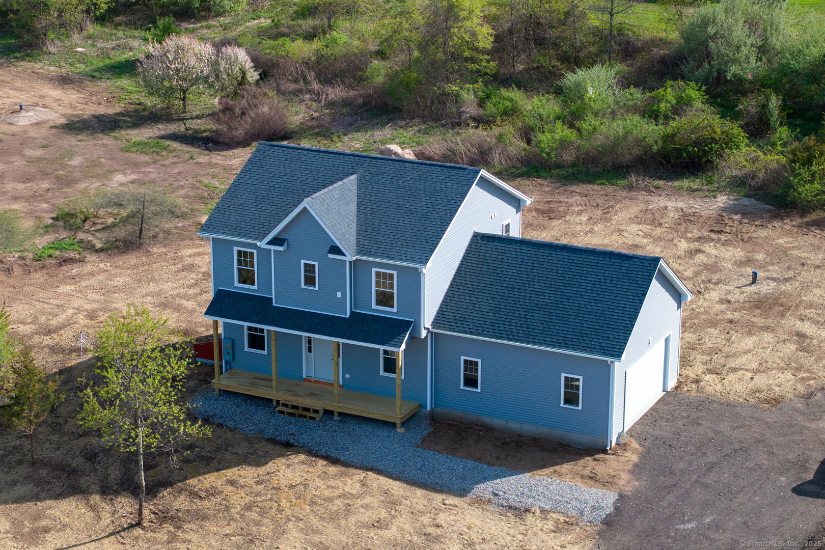 an aerial view of a house with a yard