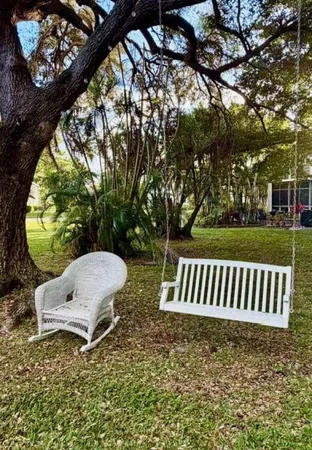 a view of a house with a yard and garden