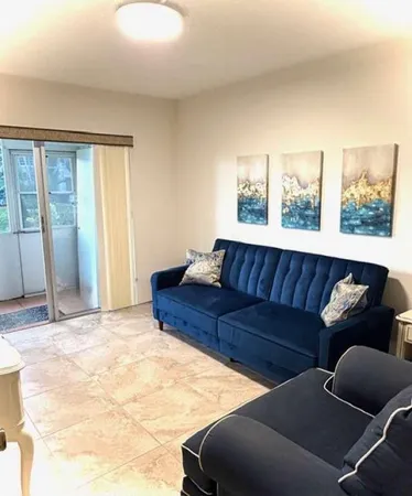 a living room with furniture and large window