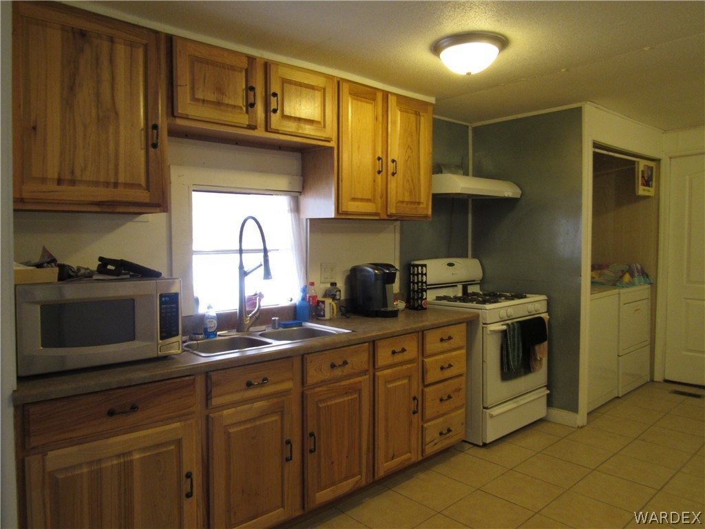 1846 Rio Grande Road Bullhead City, AZ 86442 - Photo 6 of 18 a kitchen with stainless steel appliances granite countertop a sink a stove and cabinets