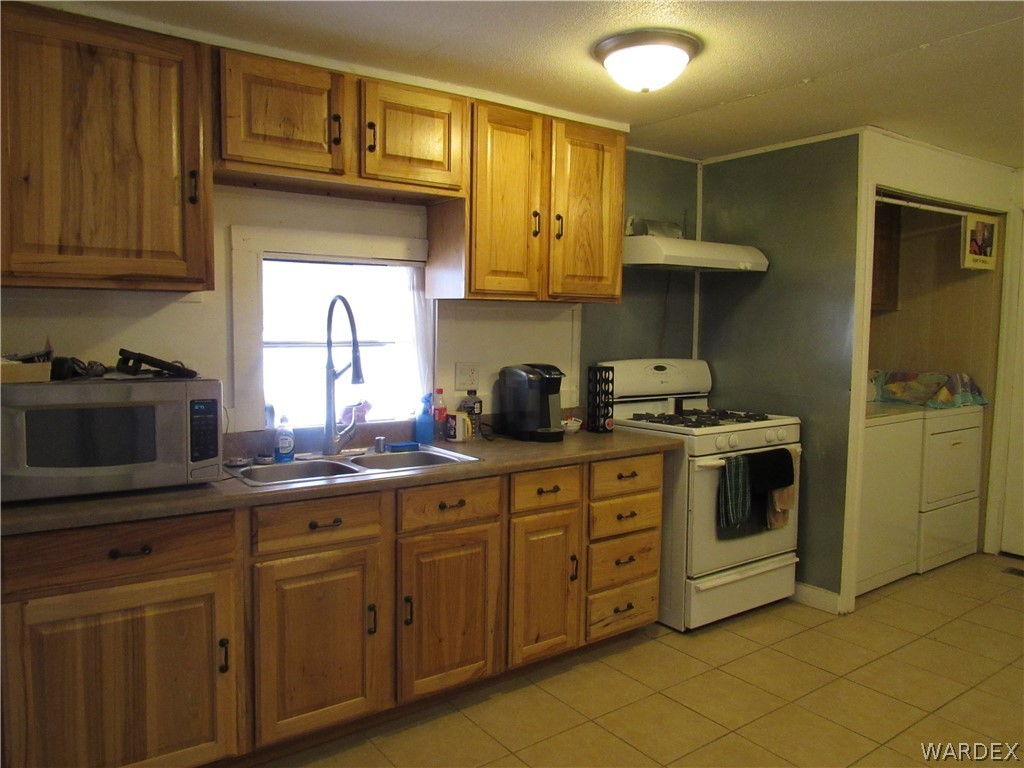 1846 Rio Grande Road Bullhead City, AZ 86442 - Photo 7 of 18 a kitchen with cabinets stainless steel appliances and a sink