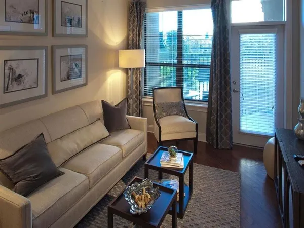 a living room with furniture and a lamp