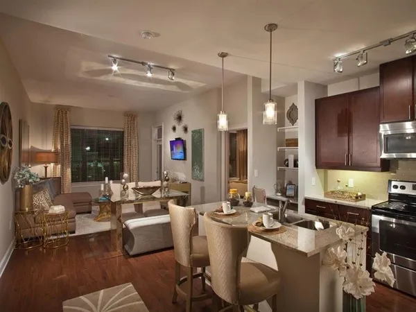 a large kitchen with a large counter space appliances and living room