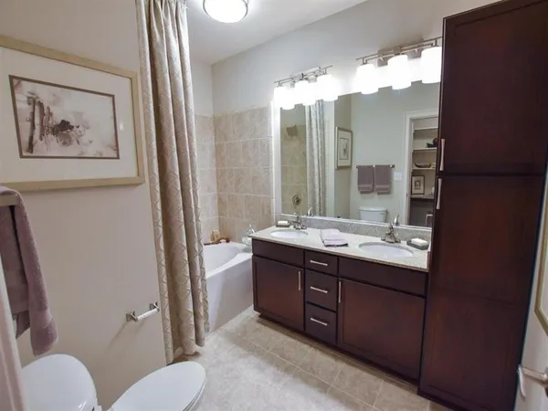 a bathroom with a double vanity sink and a mirror