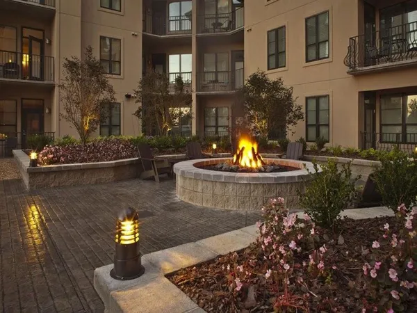 a front view of a house with a fire pit and swimming pool