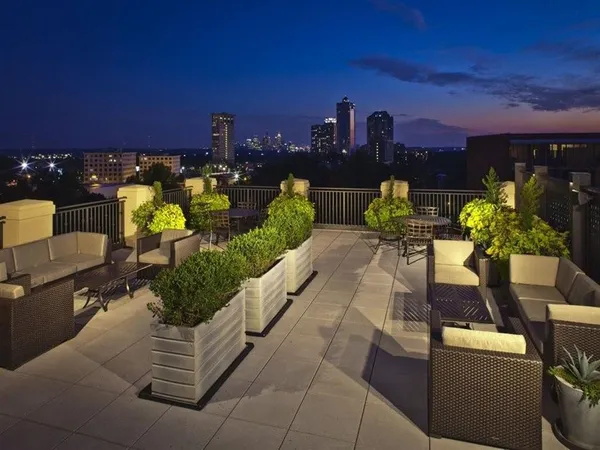 a view of a terrace with couches and potted plants