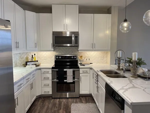 a kitchen with a sink stove and cabinets