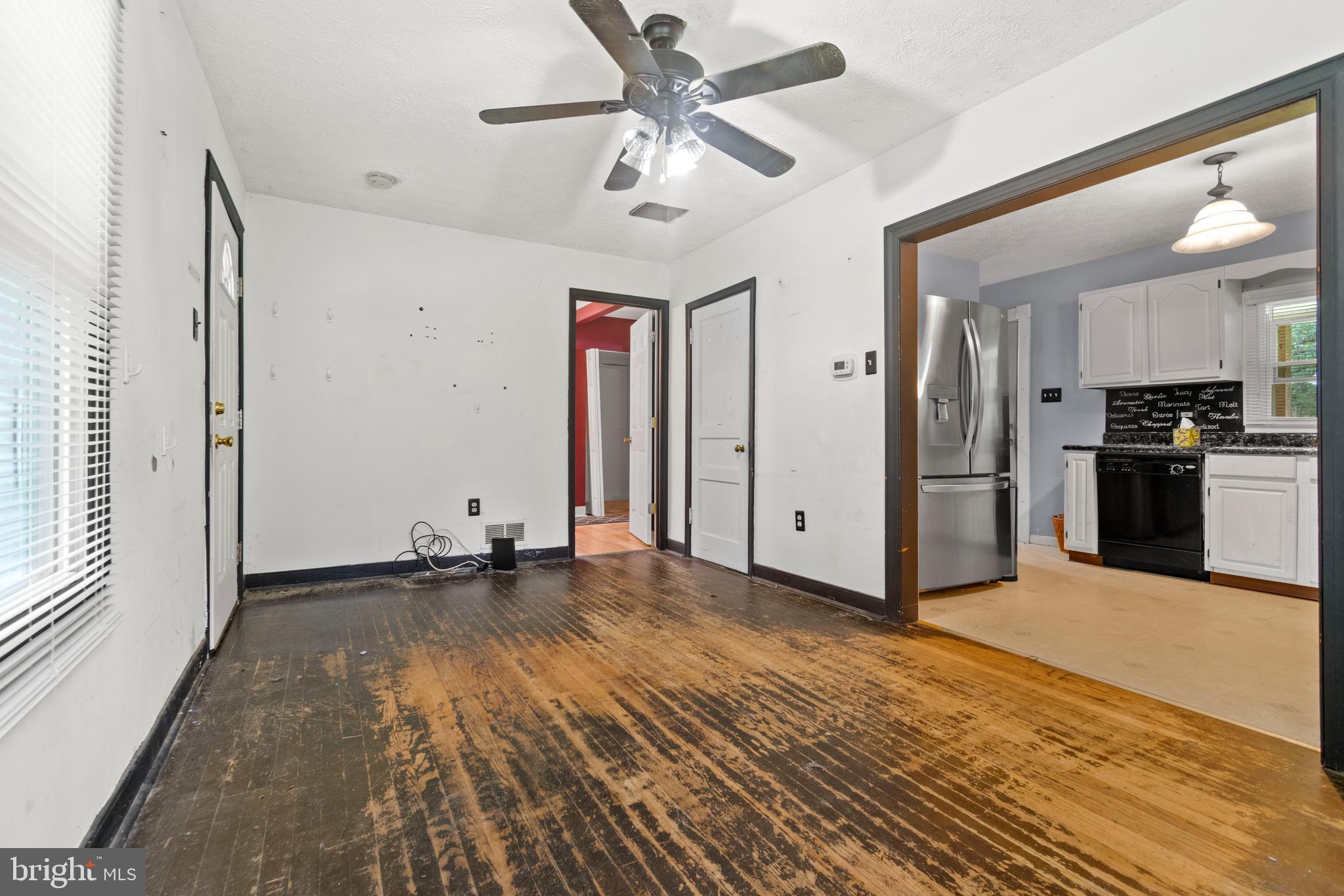 7721 Locust Wood Road Severn, MD 21144 - Photo 17 of 29 a view of a big room with wooden floor and a ceiling fan