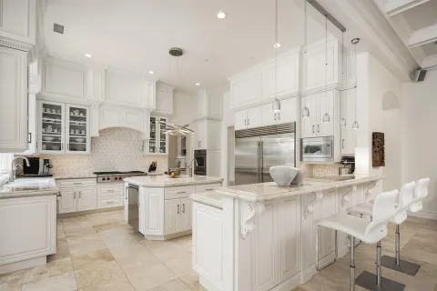 a kitchen with stainless steel appliances granite countertop a sink and cabinets
