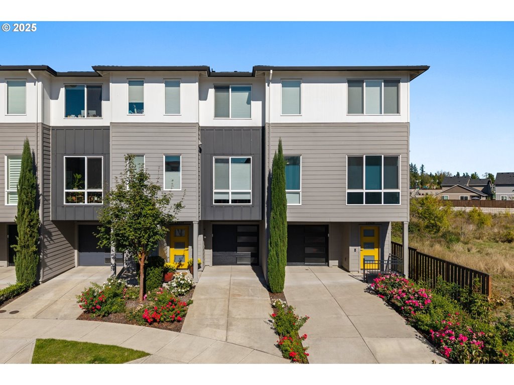 a front view of a house with a garden