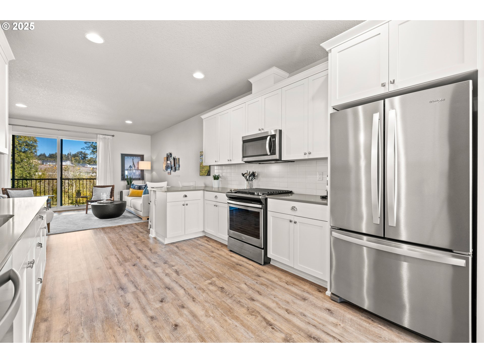 12524 Southwest 171st Terrace Beaverton, OR 97007 - Photo 11 of 40 a kitchen with stainless steel appliances a refrigerator sink and microwave