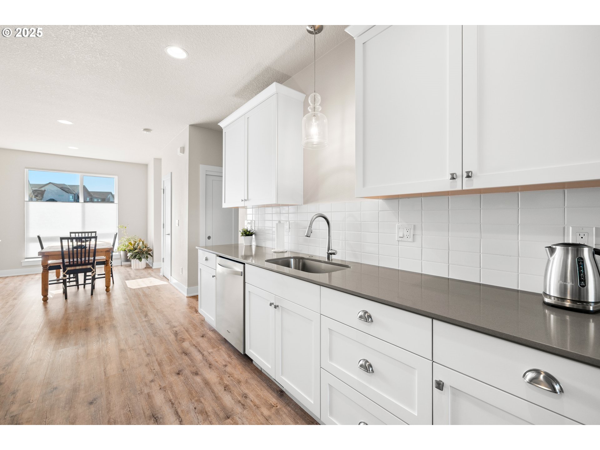 12524 Southwest 171st Terrace Beaverton, OR 97007 - Photo 19 of 40 a kitchen with sink cabinets and wooden floor