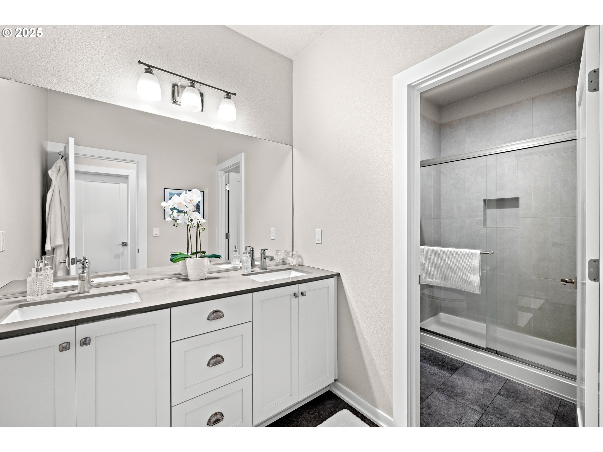 12524 Southwest 171st Terrace Beaverton, OR 97007 - Photo 23 of 40 a bathroom with a double vanity sink and mirror