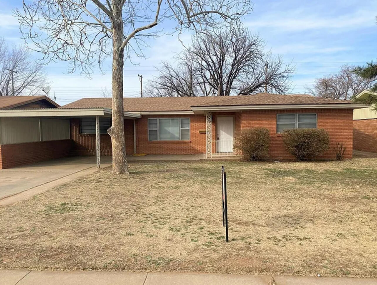 4908 43rd Street Lubbock, TX 79414 - Photo 1 of 18 a front view of a house with garden