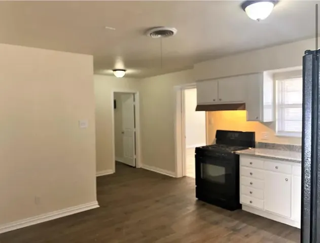 a kitchen with a refrigerator and window