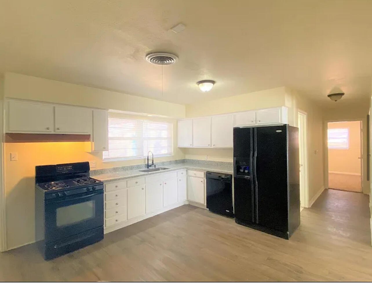 4908 43rd Street Lubbock, TX 79414 - Photo 5 of 18 a kitchen with stainless steel appliances granite countertop a refrigerator and a sink