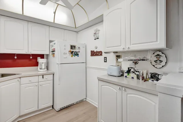 a kitchen with a sink a stove and cabinets