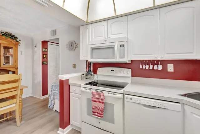 a bathroom with a granite countertop sink mirror vanity and toilet
