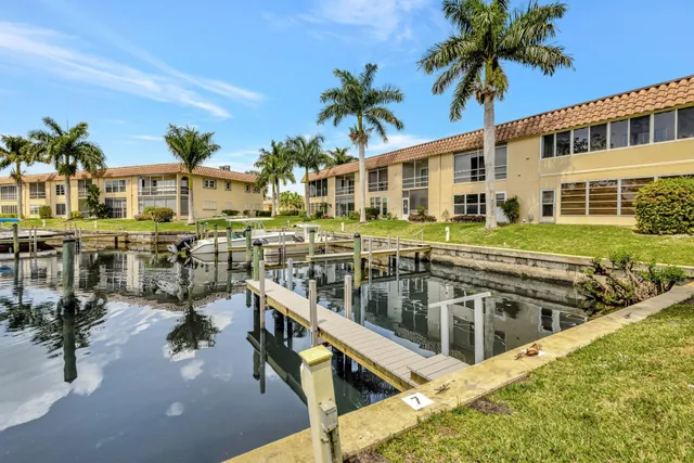 a view of a house with swimming pool and sitting area