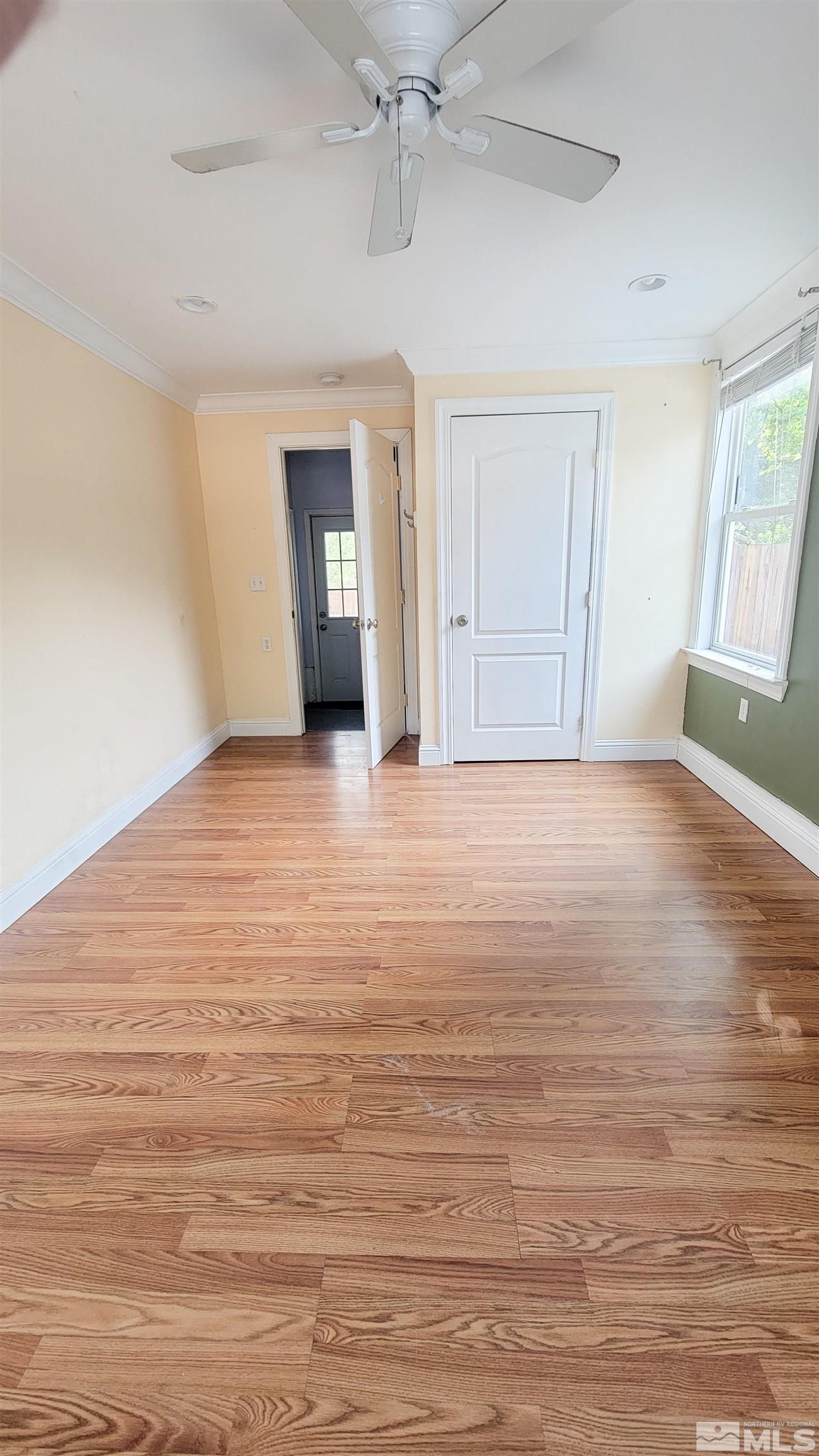240 Bisby Street Reno, NV 89512 - Photo 11 of 27 a view of an empty room with window and wooden floor