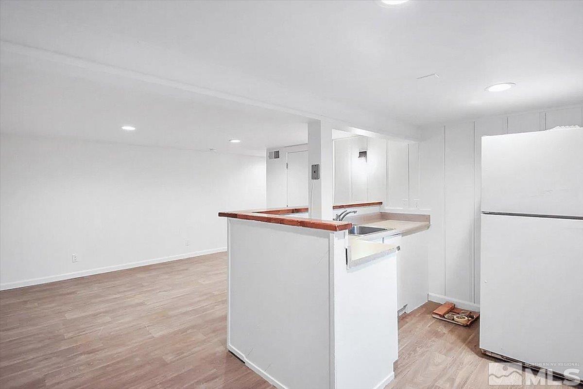 240 Bisby Street Reno, NV 89512 - Photo 13 of 27 a view of kitchen with refrigerator sink and wooden floor