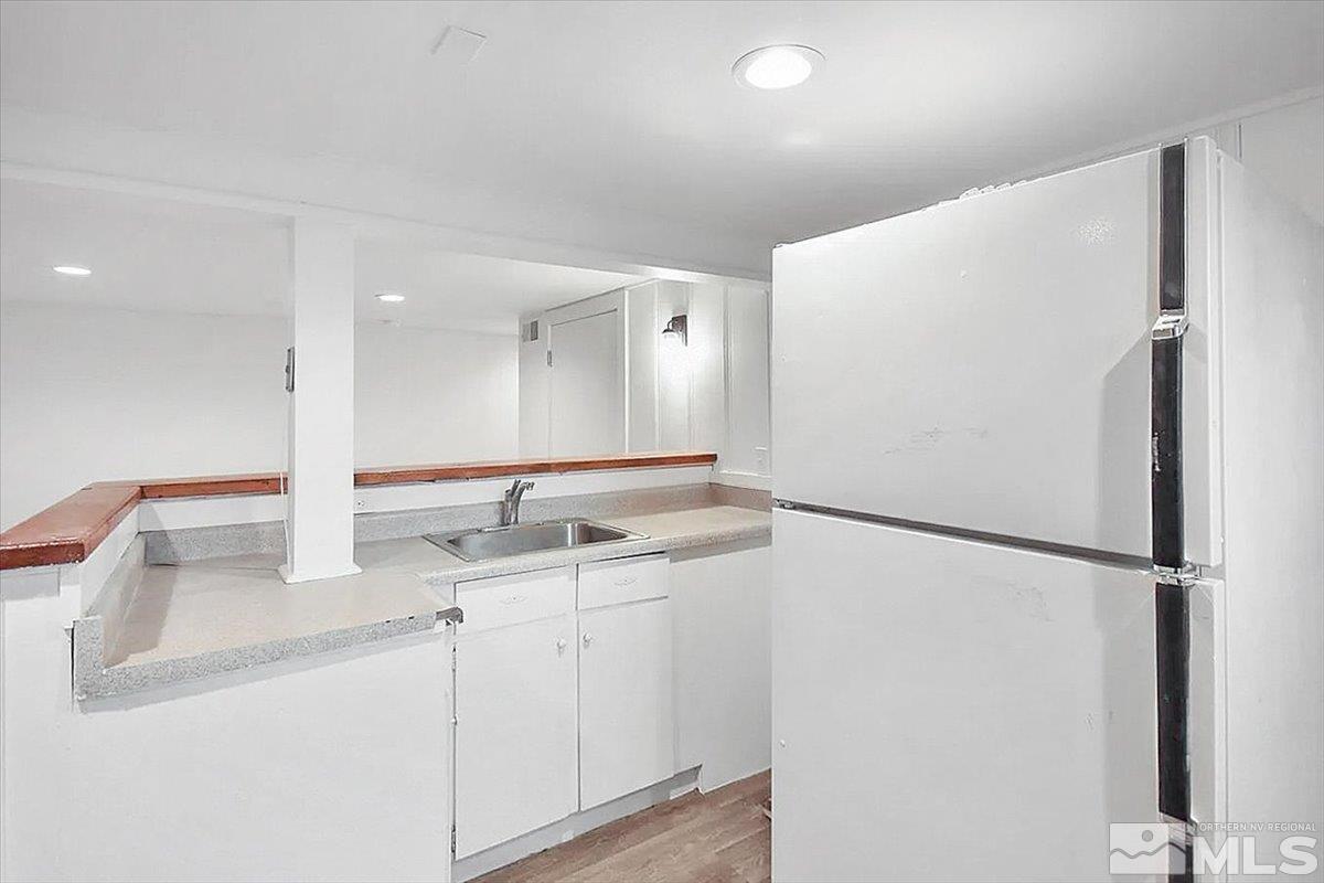 240 Bisby Street Reno, NV 89512 - Photo 14 of 27 a kitchen with a refrigerator and a sink