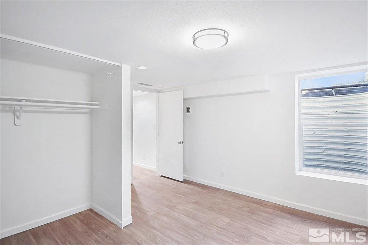 240 Bisby Street Reno, NV 89512 - Photo 15 of 27 a view of an empty room with wooden floor